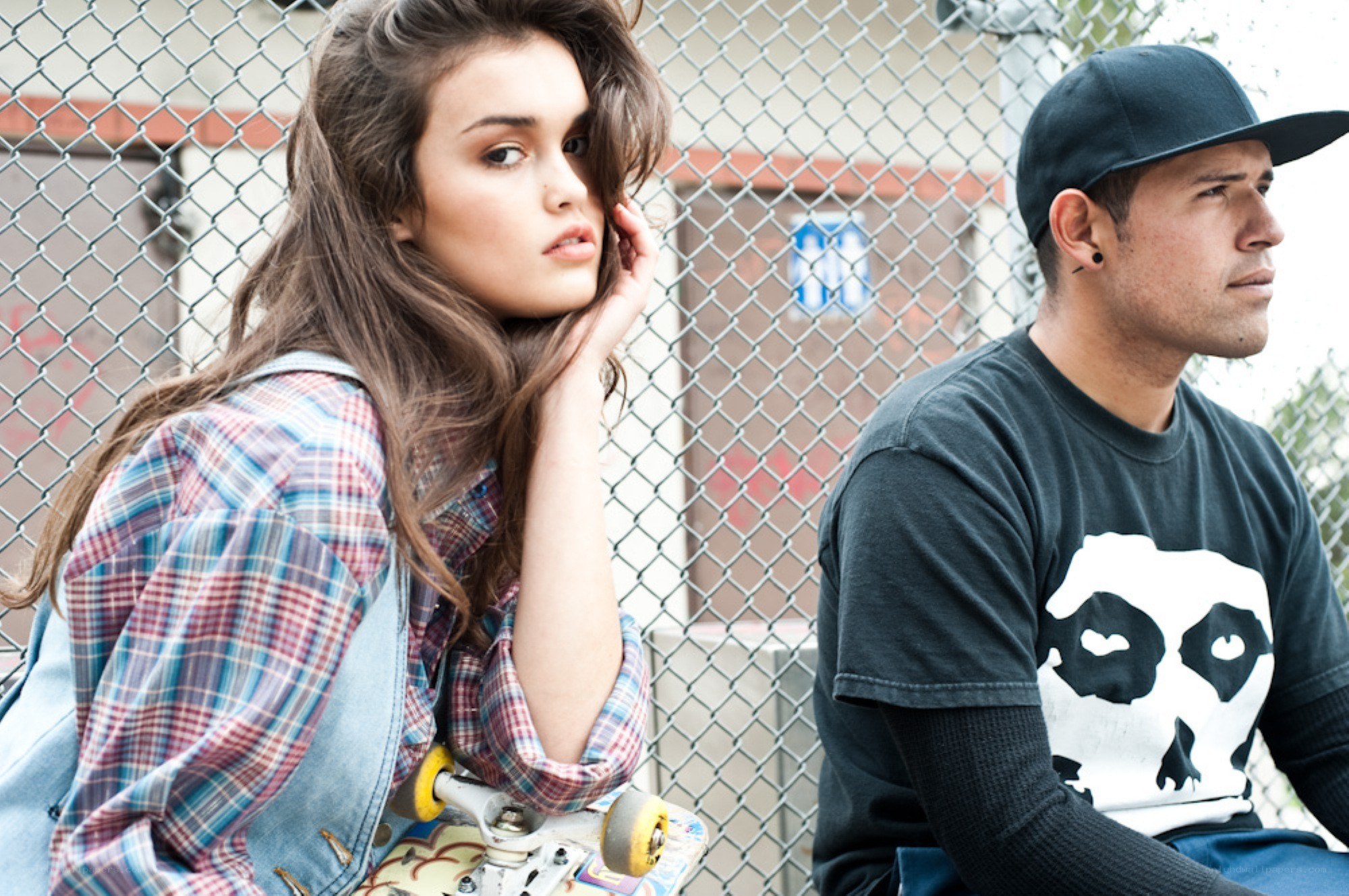 Two people with a skateboard