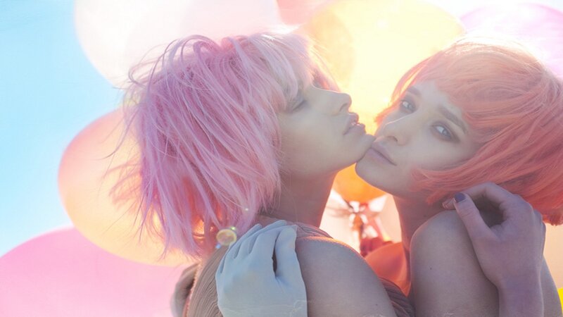Two people with colorful hair embracing