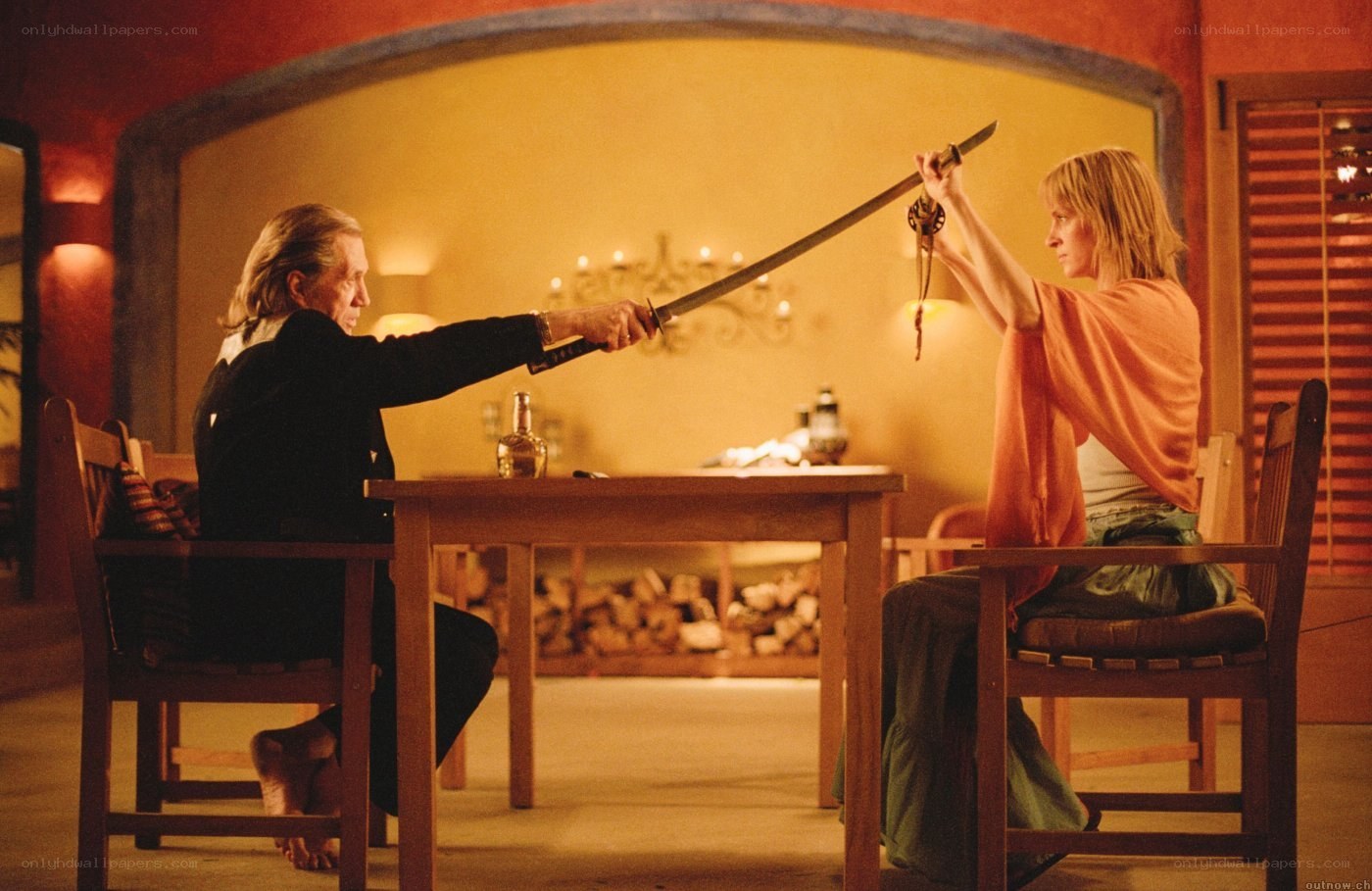 Two people with swords at a table