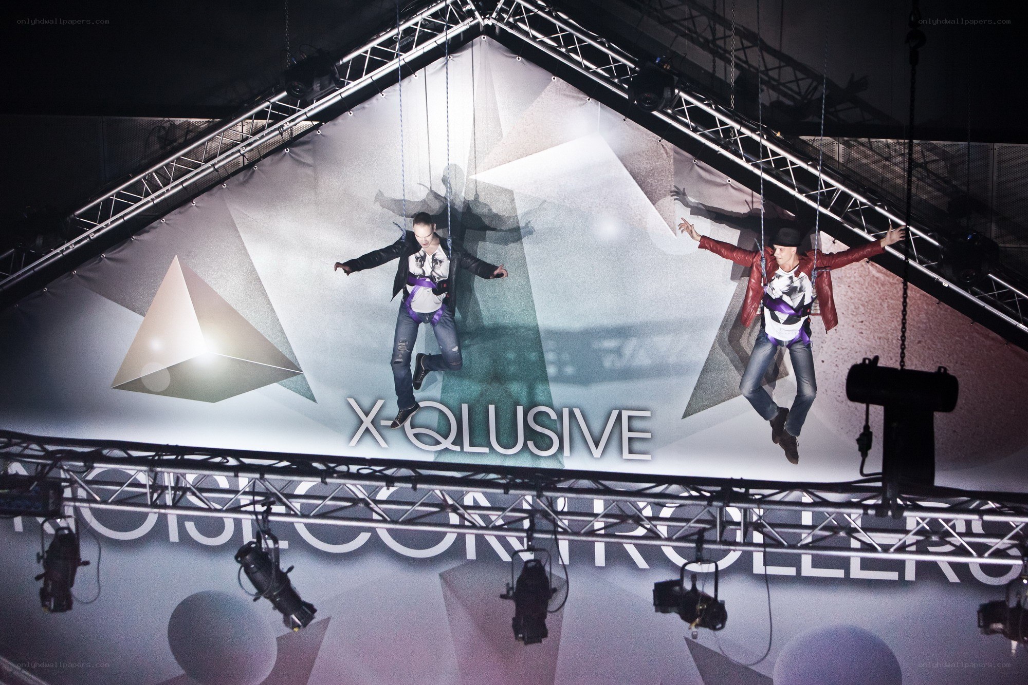 Two performers suspended on stage