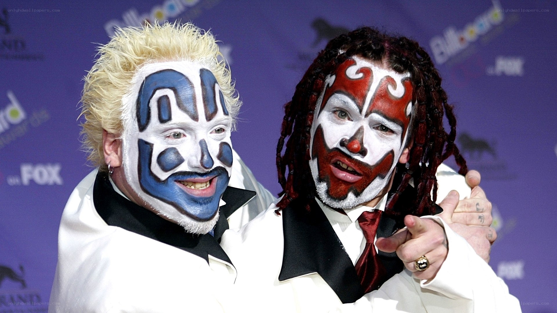 Two performers with face paint on red carpet