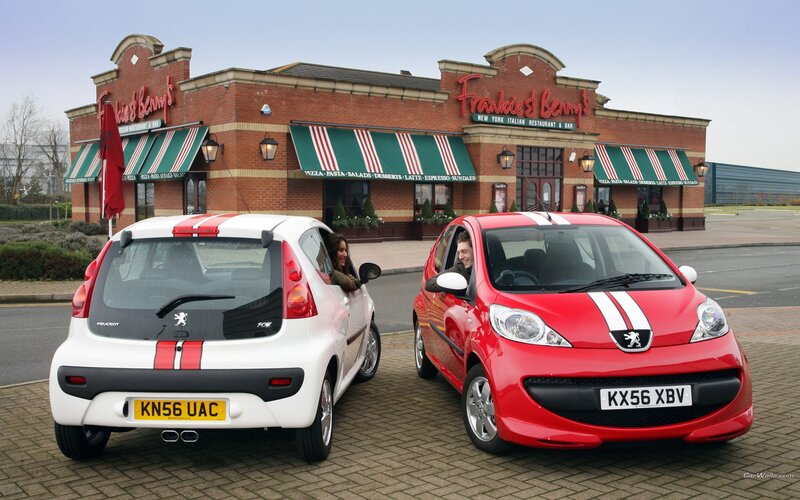 Two Peugeot cars at a restaurant