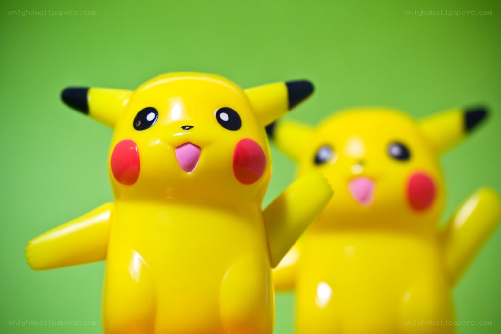 Two Pikachu toys on green