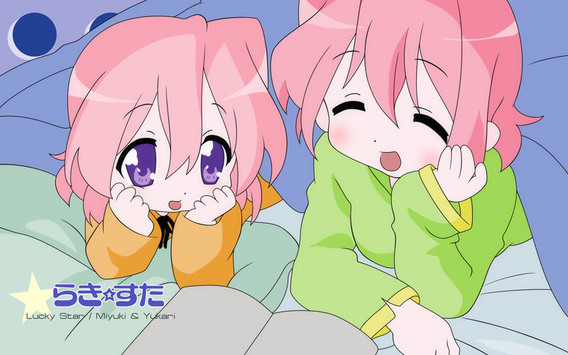 Two pink-haired girls in bed