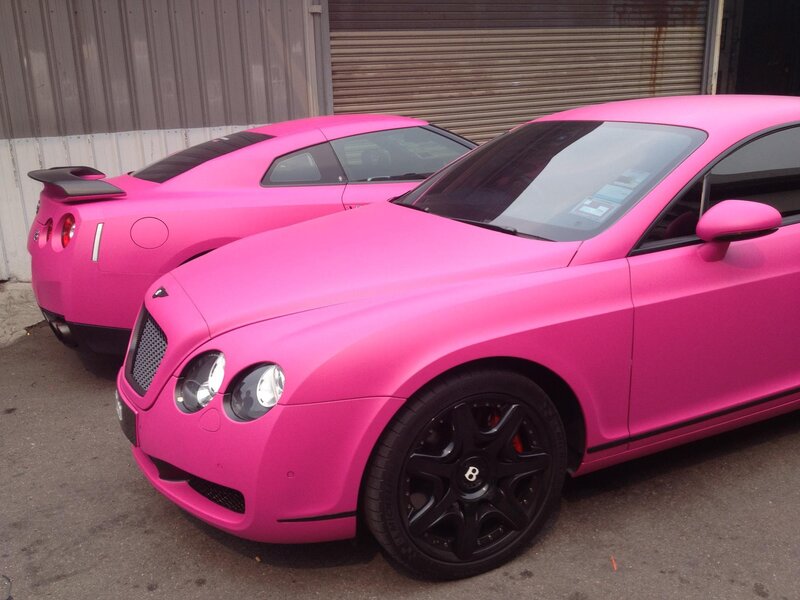 Two pink sports cars