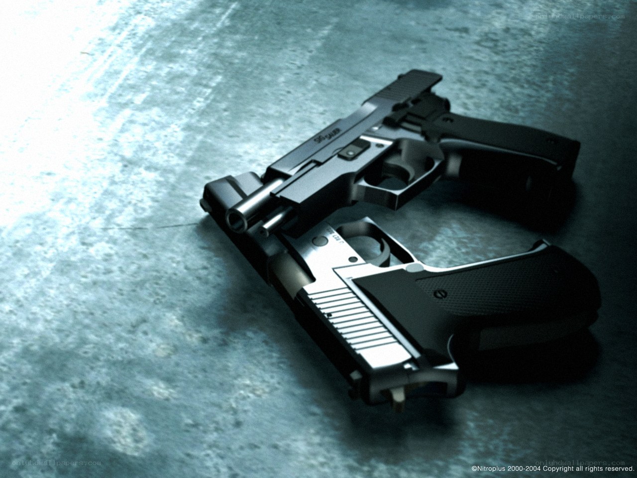 Two pistols on concrete