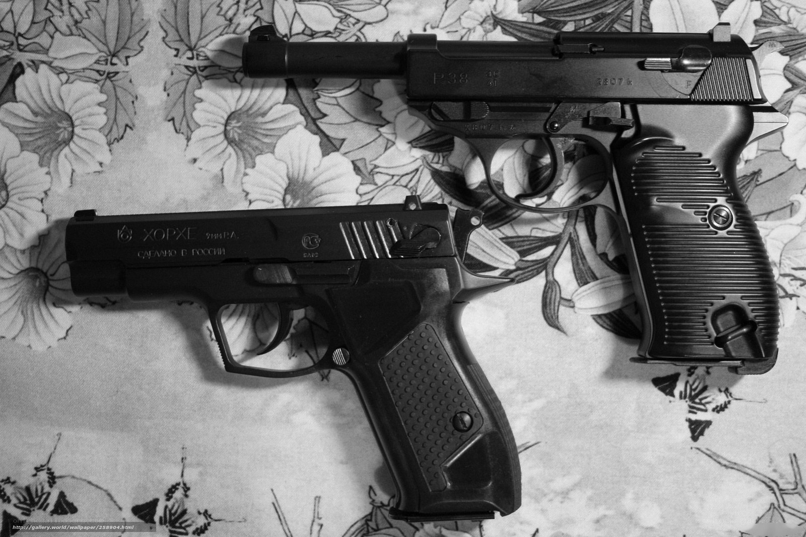 Two pistols on floral fabric