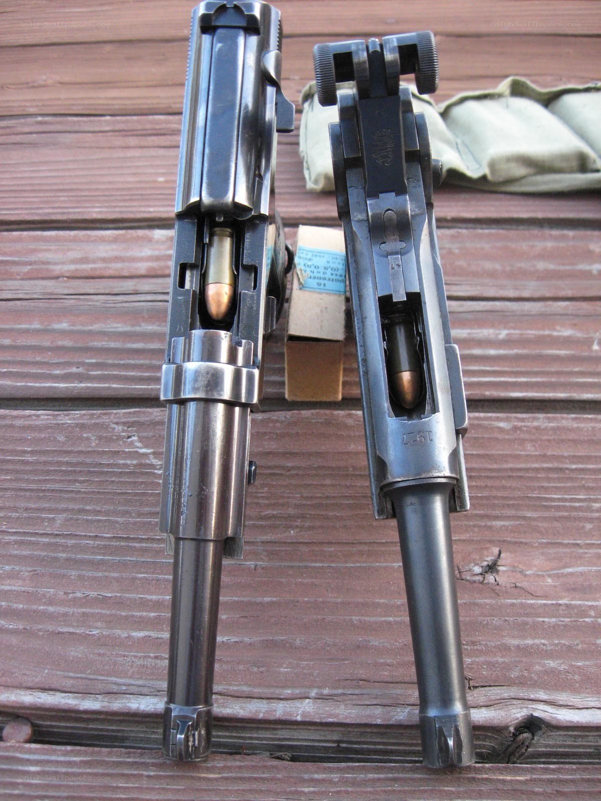 two pistols on wooden surface
