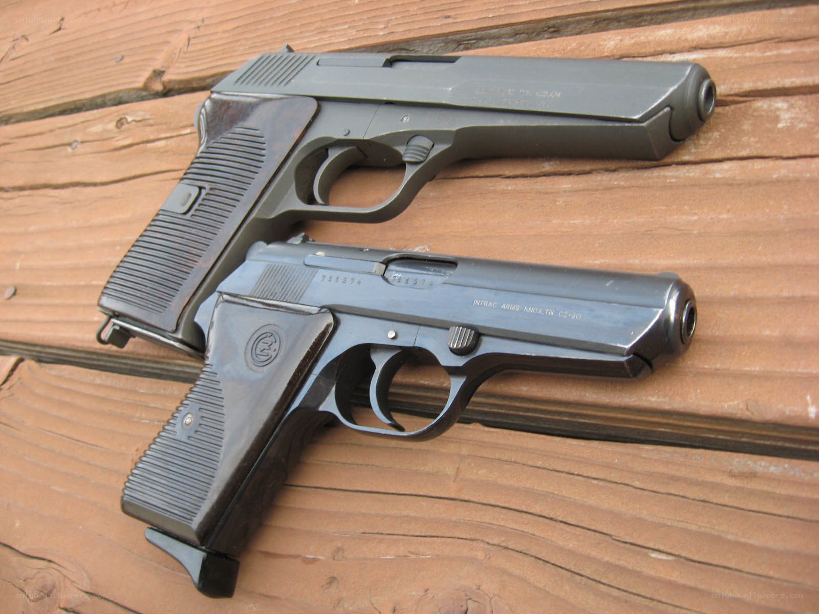 Two pistols on wooden surface