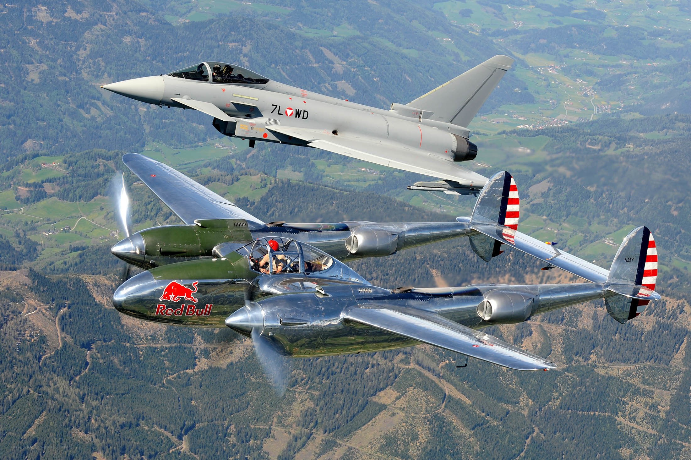 Two planes flying over mountains