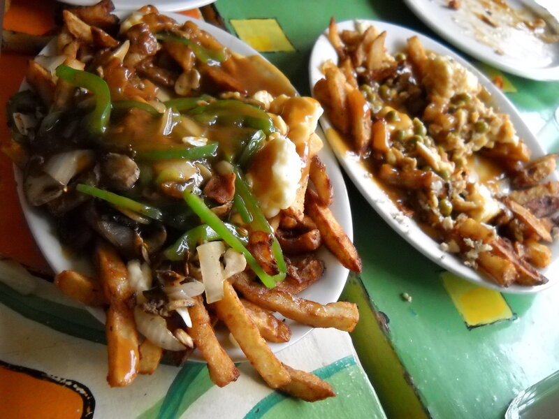 Two plates of poutine