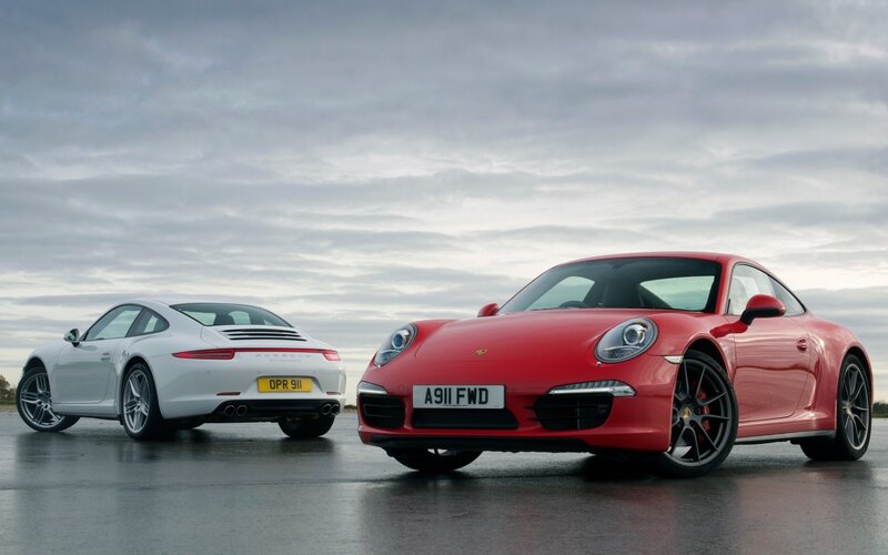 Two Porsche 911 cars on tarmac