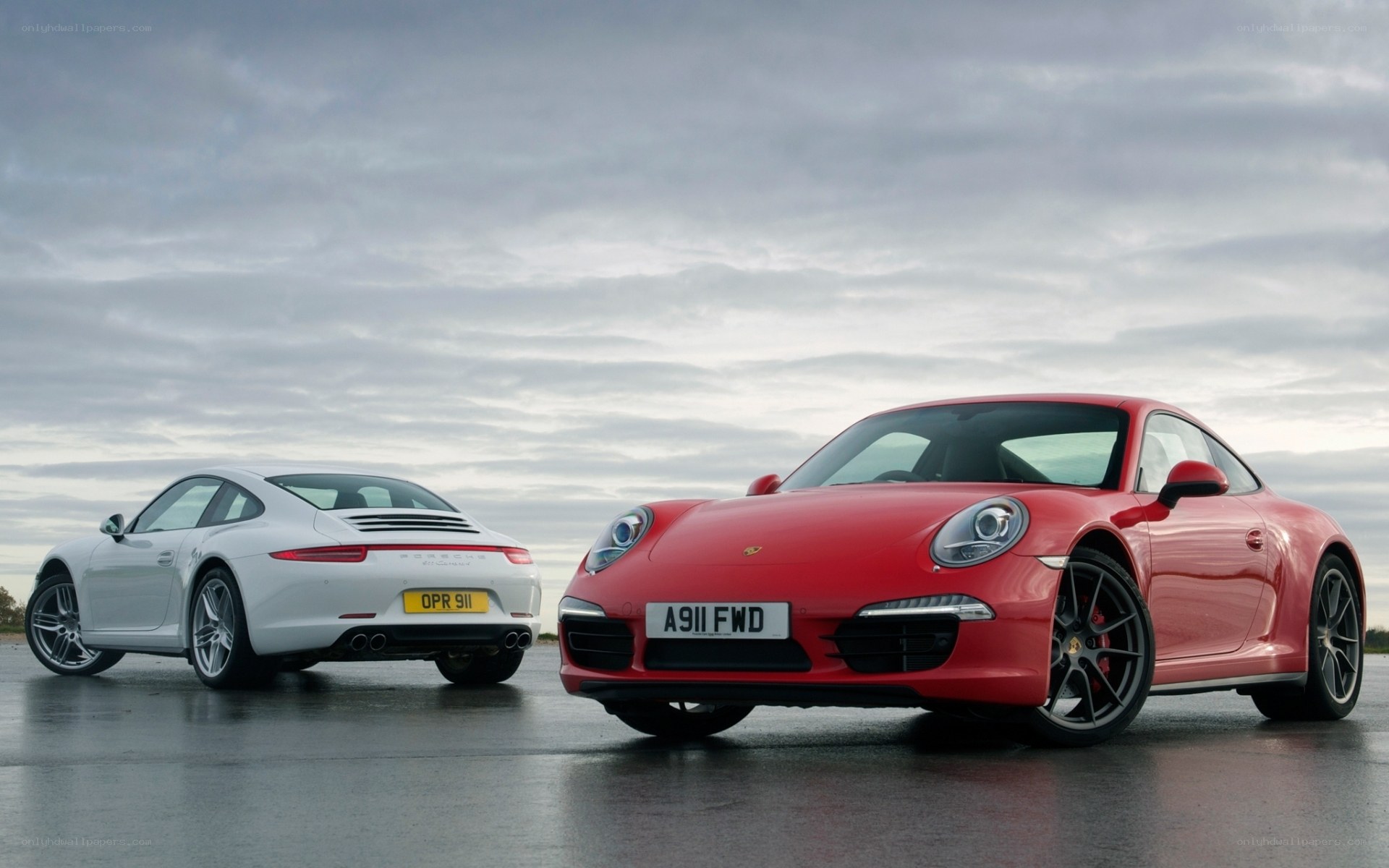 Two Porsche 911 cars on tarmac