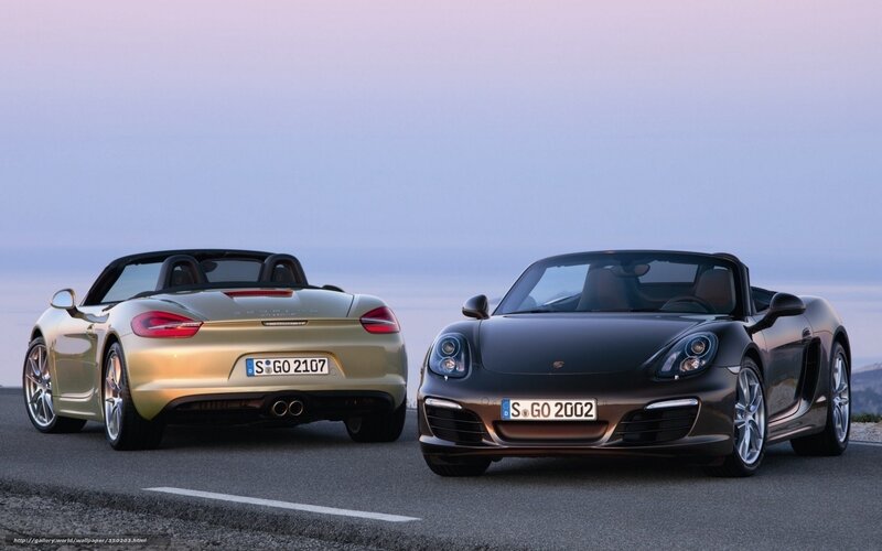 Two Porsche Boxster cars on a road