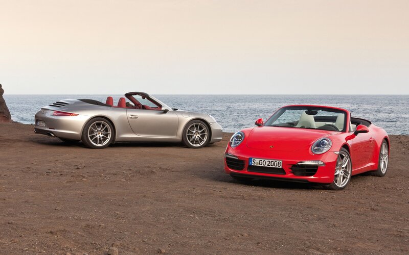 Two Porsche convertibles by the sea