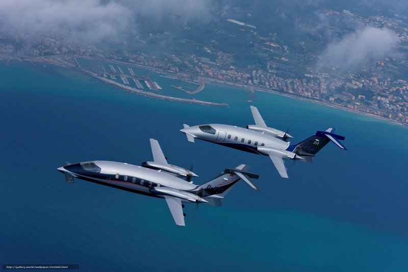 Two private jets flying over coast