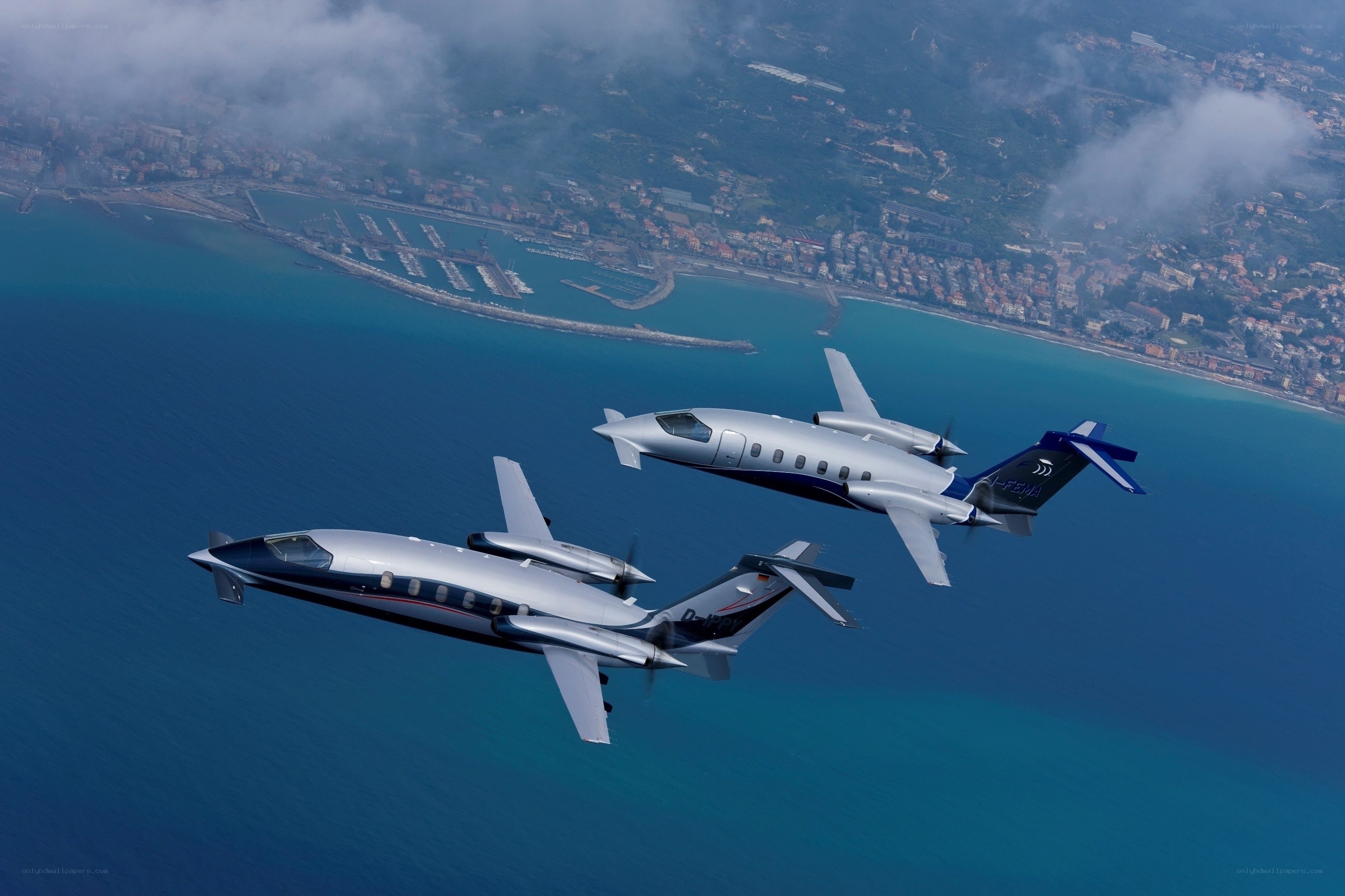 Two private jets flying over the coast