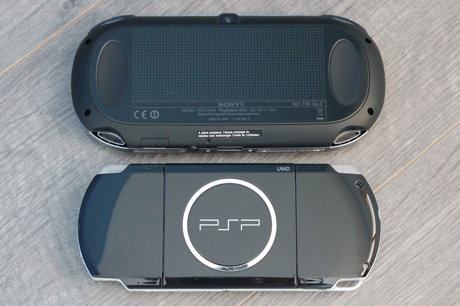Two PSP consoles on wood