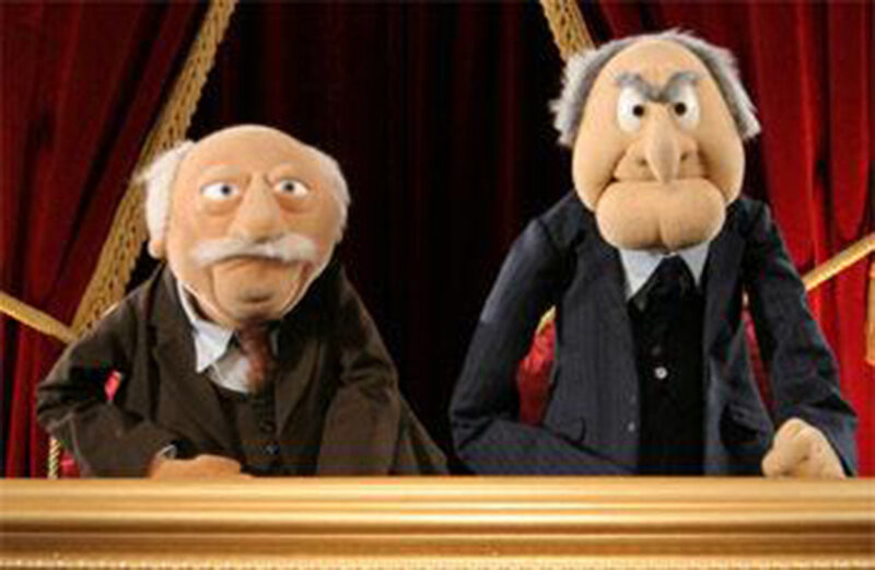 Two puppet characters at a desk