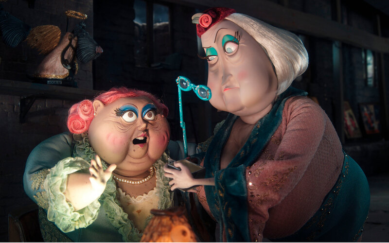 Two puppet characters in a workshop
