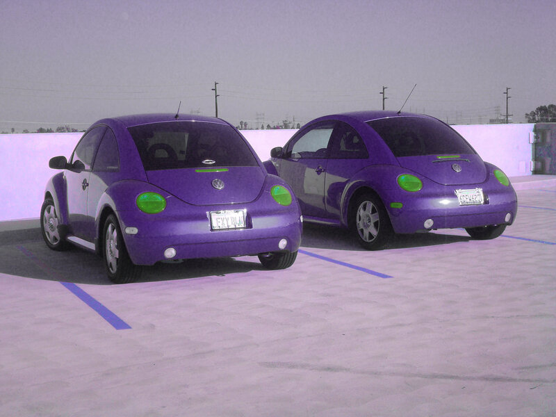 Two purple Volkswagen Beetles