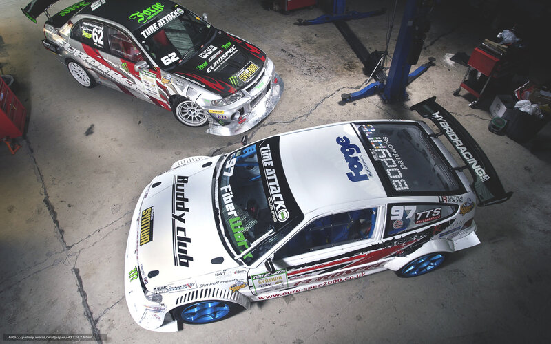 Two race cars in a garage