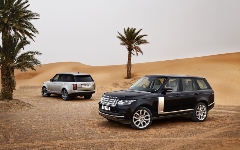 Two Range Rover SUVs — Black, Serene, Afternoon, Photograph, Palm Trees, Sand Dunes