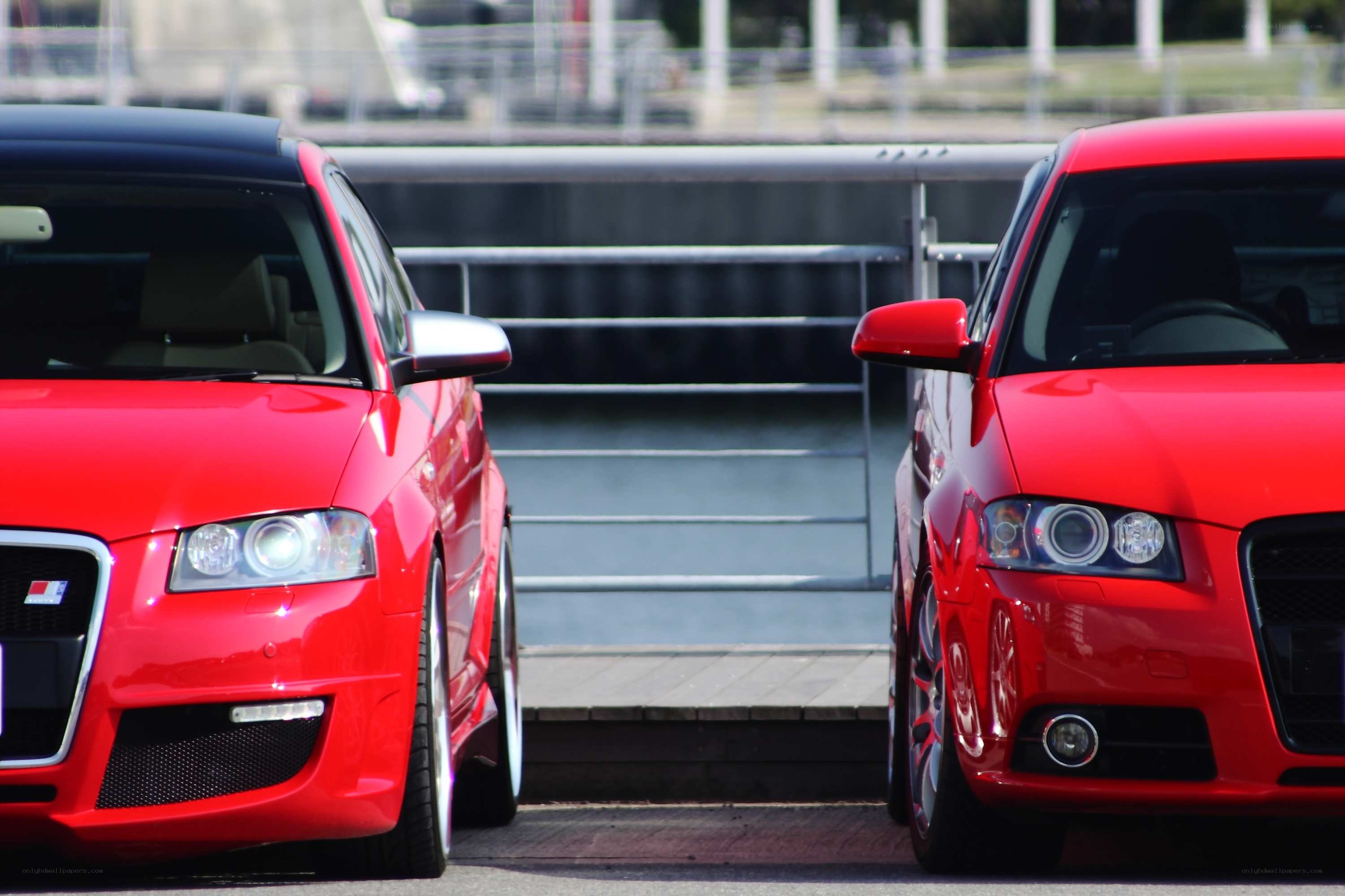 Two red Audi cars side by side