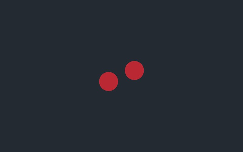 two red circles on dark background