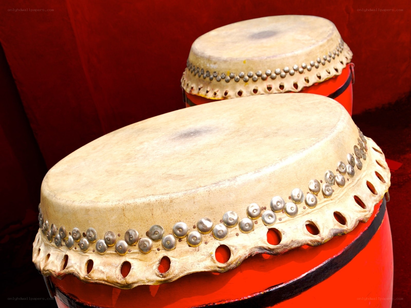 Two red drums with leather heads