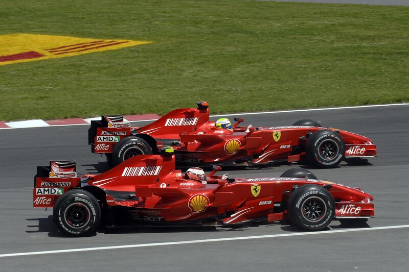 Two red F1 cars racing
