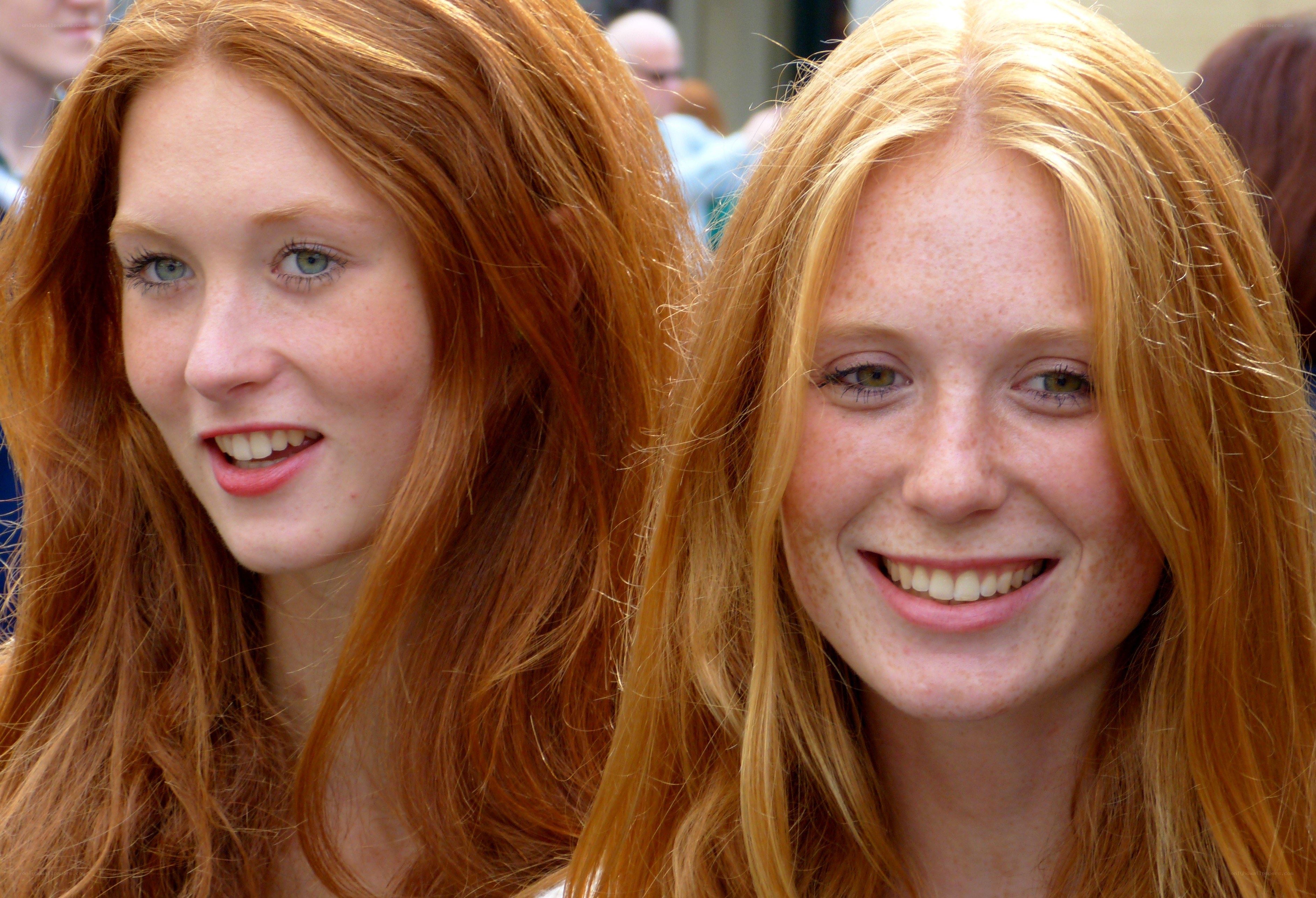 two red-haired women smiling