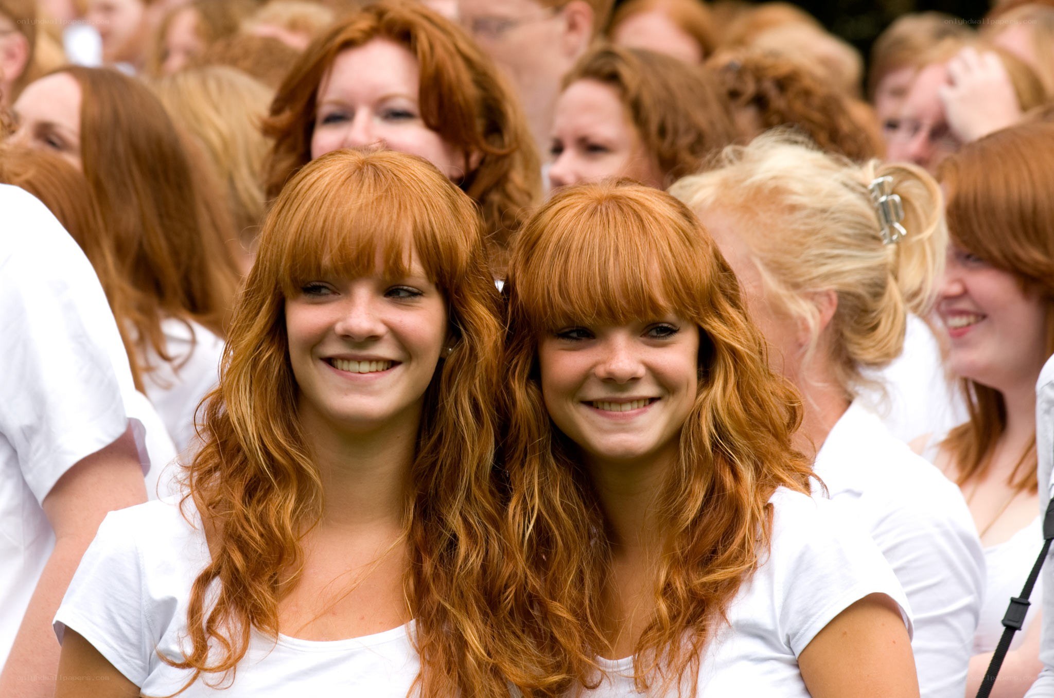 two red-haired women smiling
