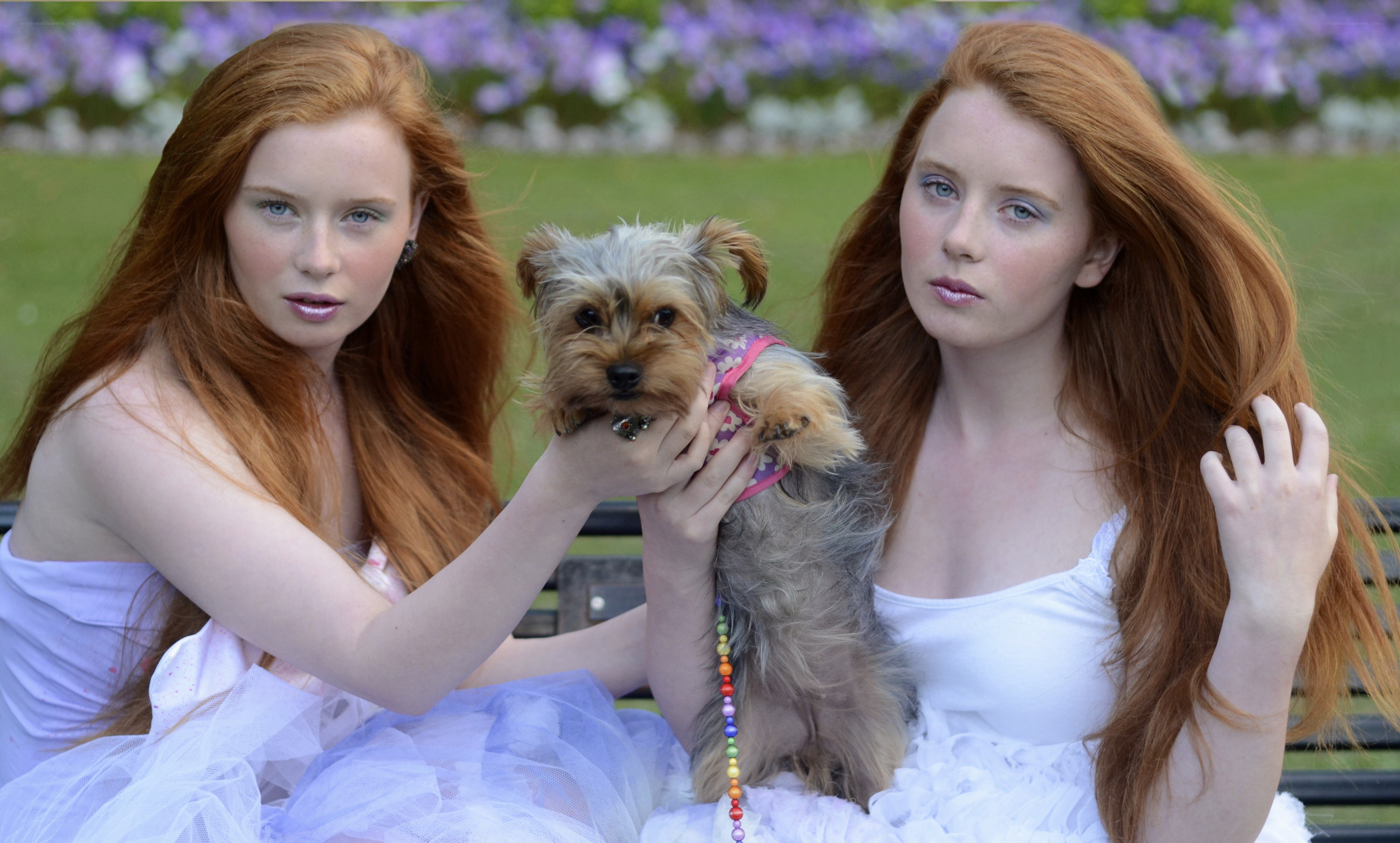 Two red-haired women with a dog