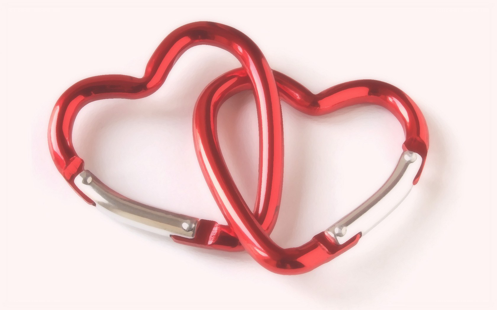 Two red heart-shaped carabiners