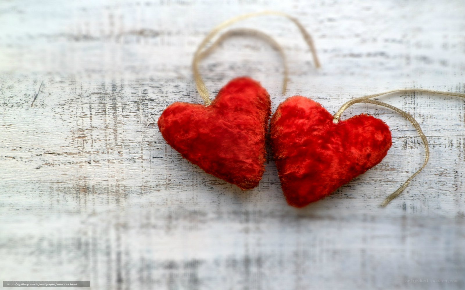 Two red hearts on wood