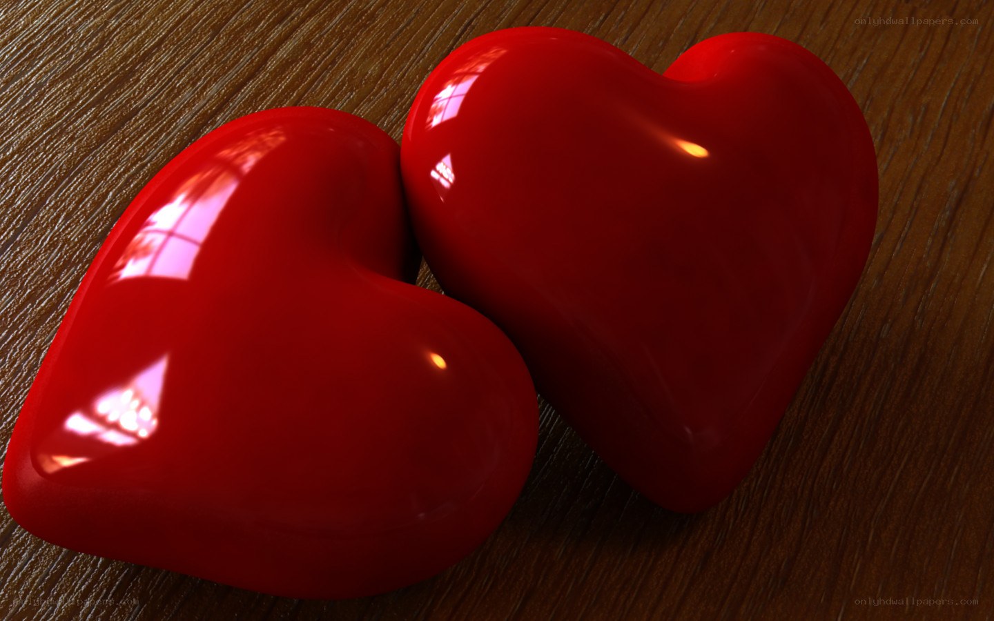 Two red hearts on wood