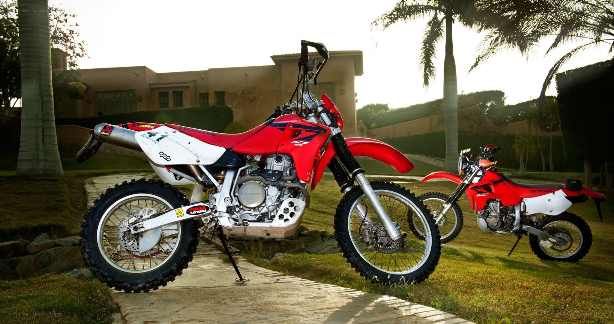Two red Honda dirt bikes