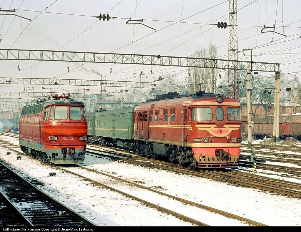 Two red locomotives on snowy tracks