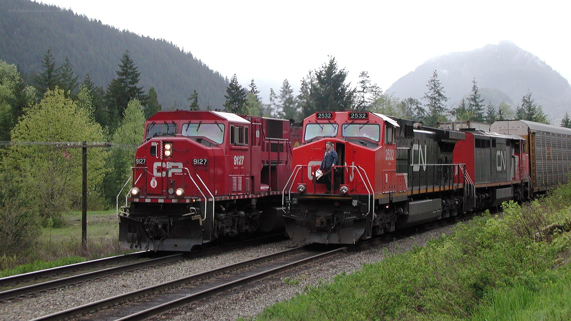 Two red locomotives on tracks