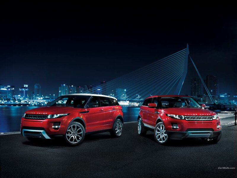 Two red Range Rovers at night