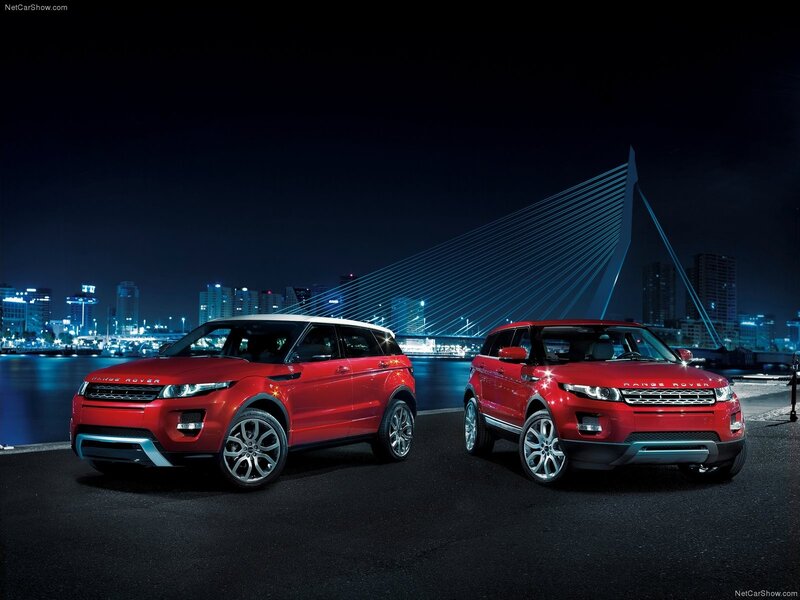 Two red Range Rovers at night