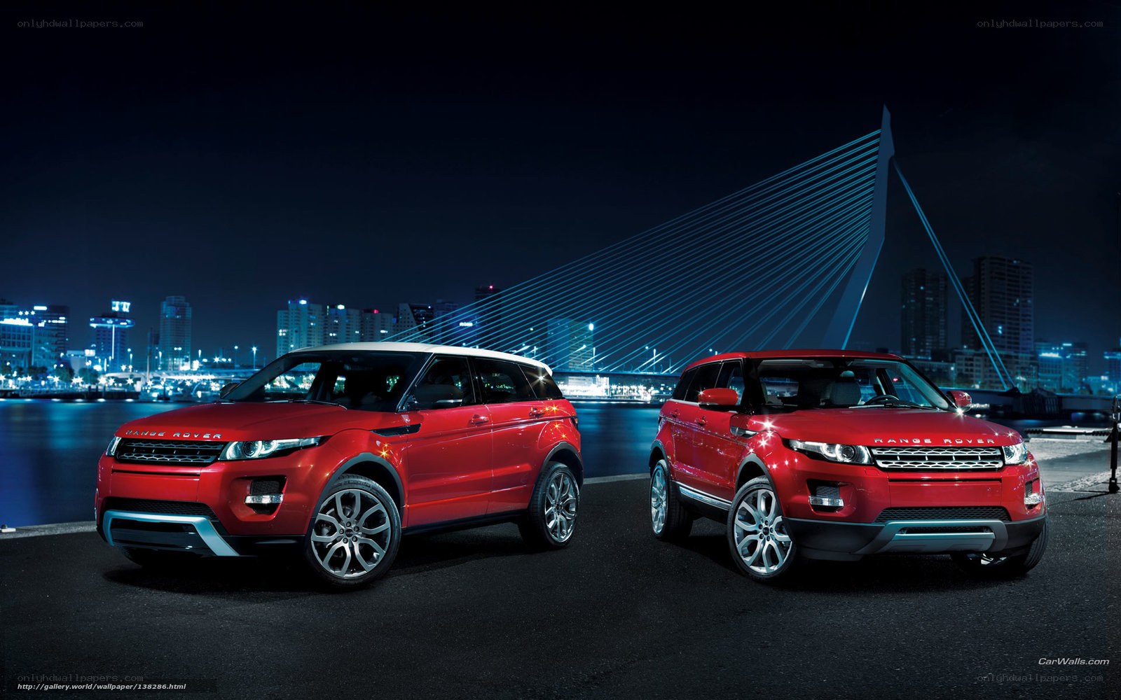 Two red Range Rovers at night