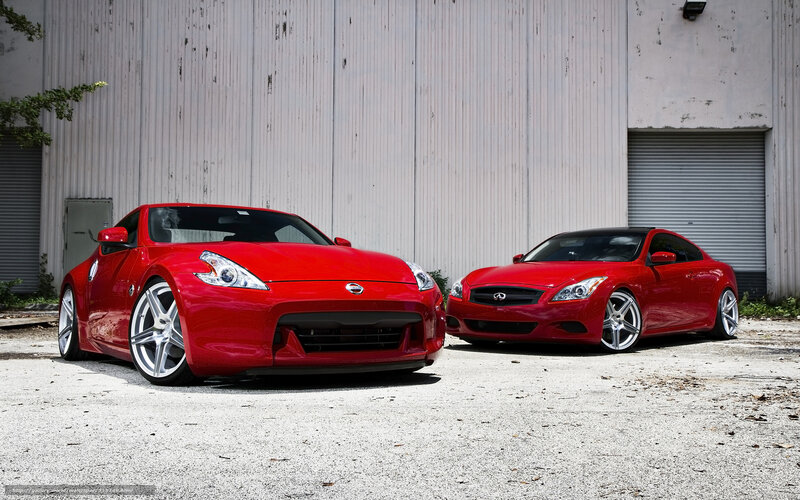 Two red sports cars parked