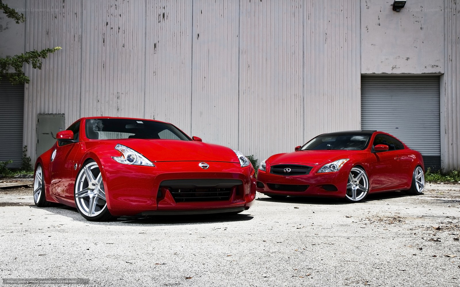Two red sports cars parked