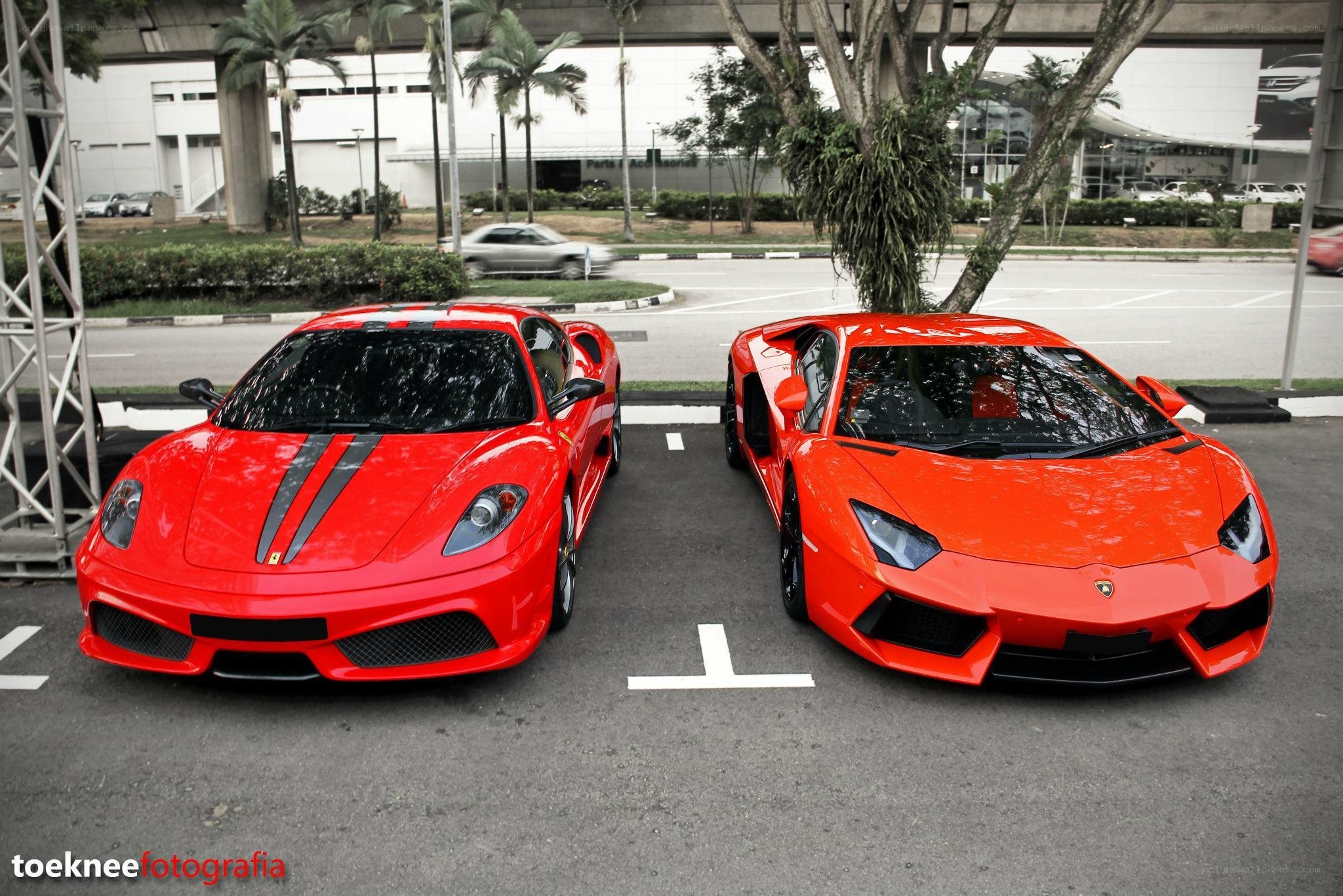 Two red supercars parked