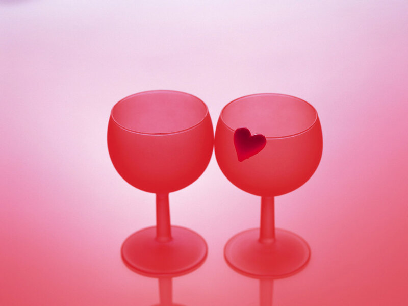 Two red wine glasses with heart