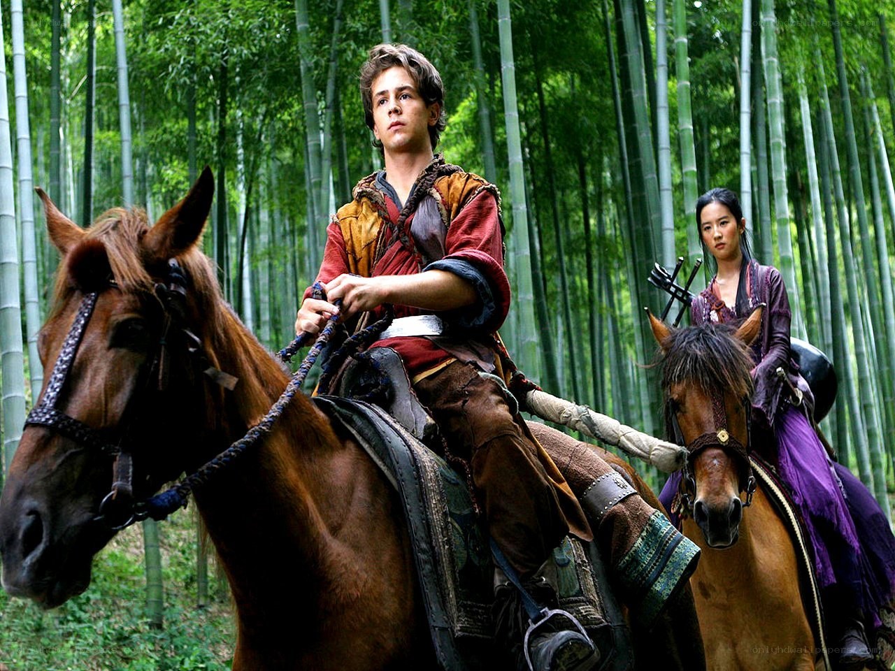 Two riders in a bamboo forest