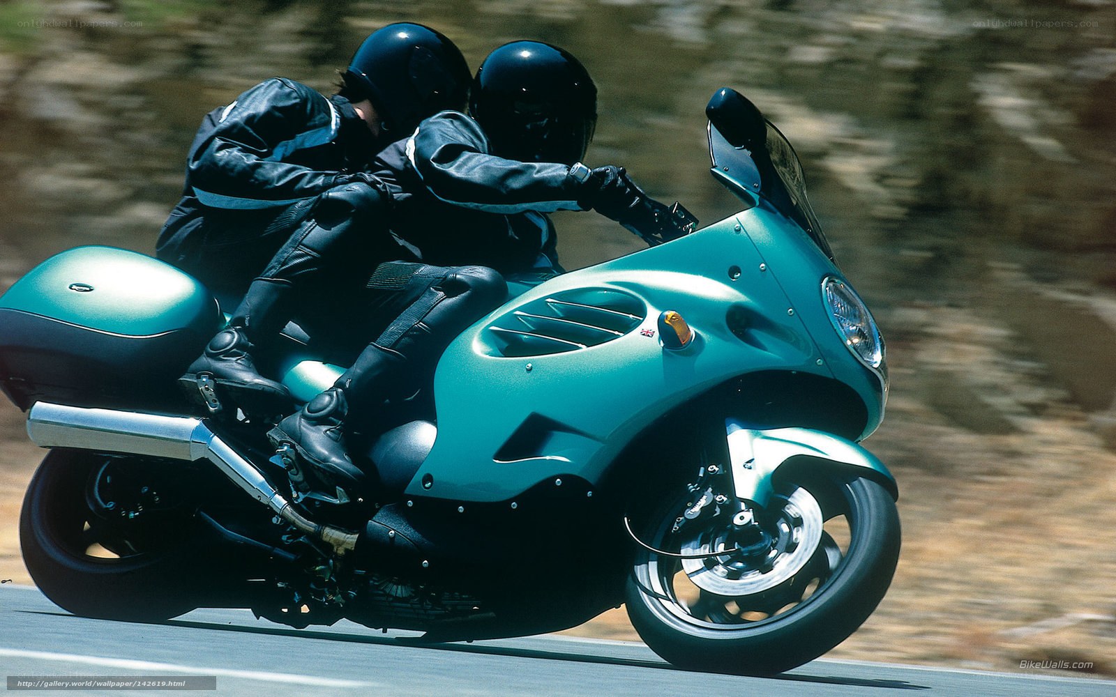 Two riders on a teal motorcycle