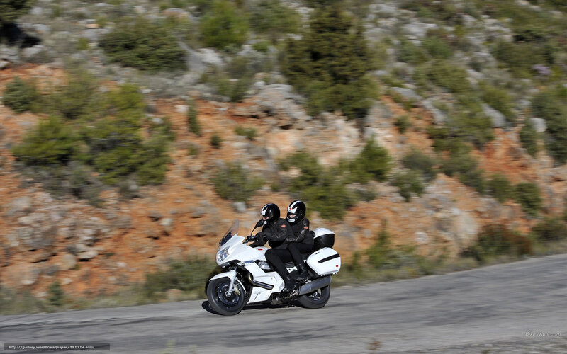Two riders on a white motorcycle